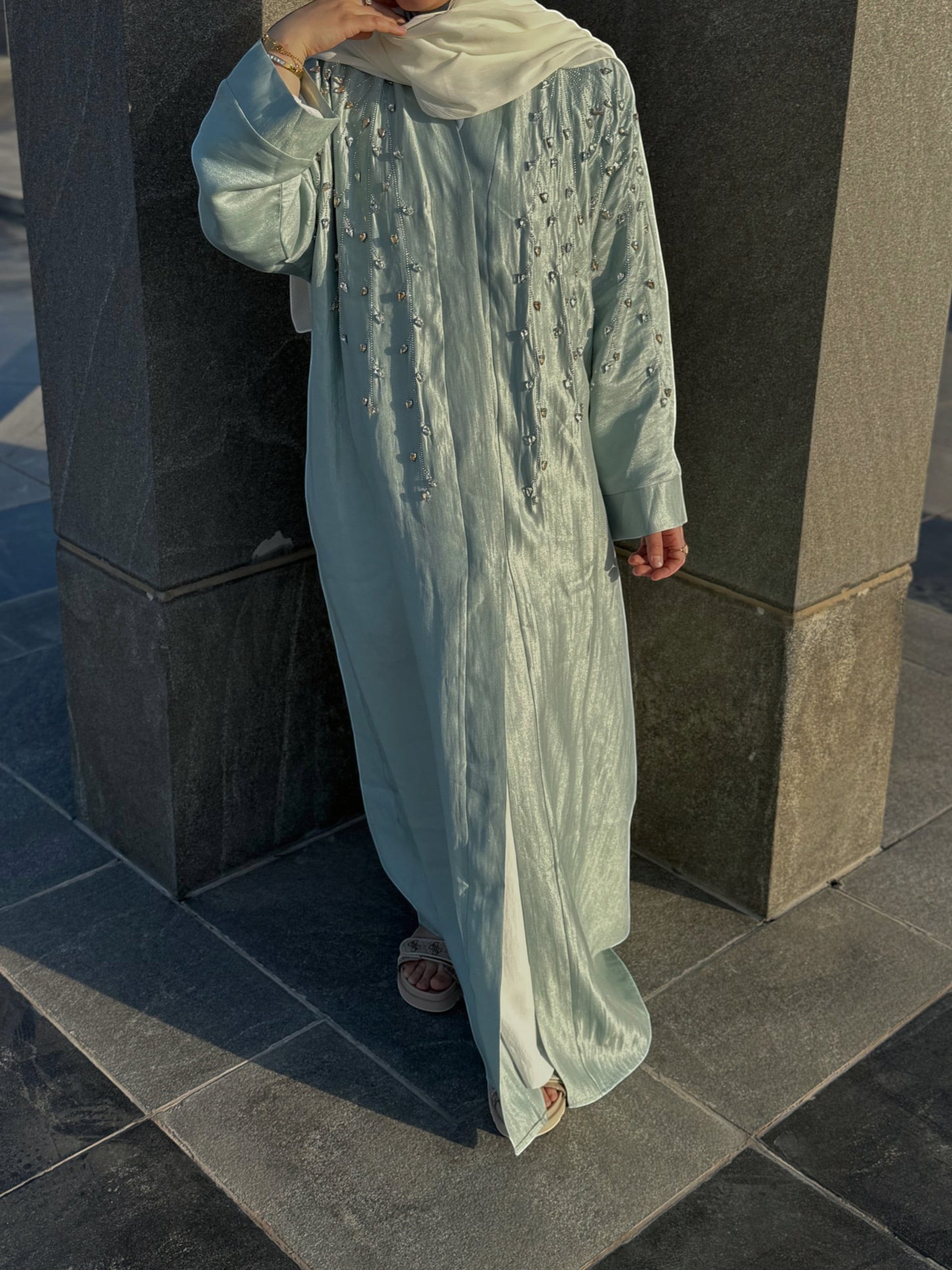 Nesthetics light blue flowing abaya with intricate bead and stone embroidery on the chest and sleeves. Long sleeves, modest design, ideal for special occasions.