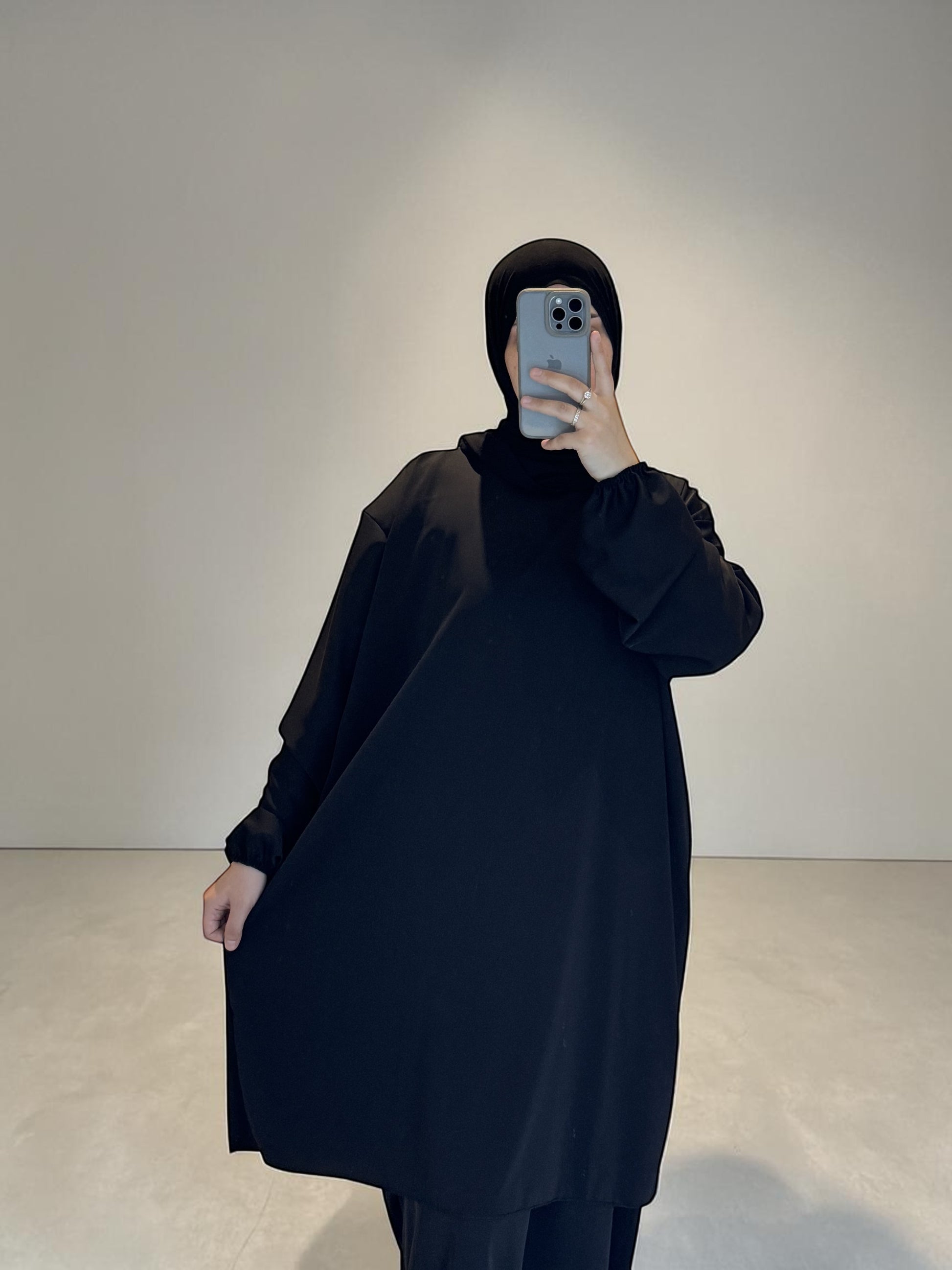 Nesthetics black 2-in-1 abaya made of Medina silk, featuring a long tunic and an underdress. Standard size, 140cm length.