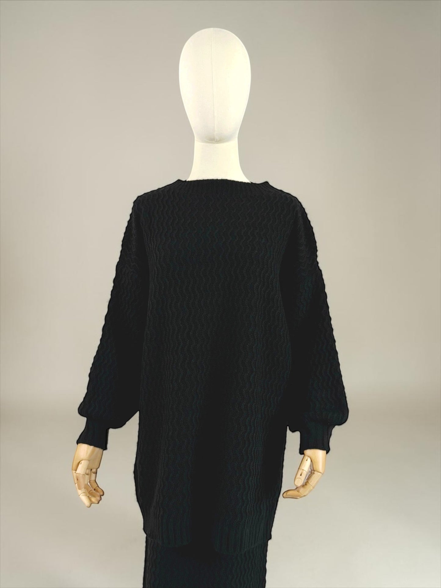 Nesthetics black knit set with zigzag pattern, balloon sleeves, and ribbed cuffs. Elegant and cozy.