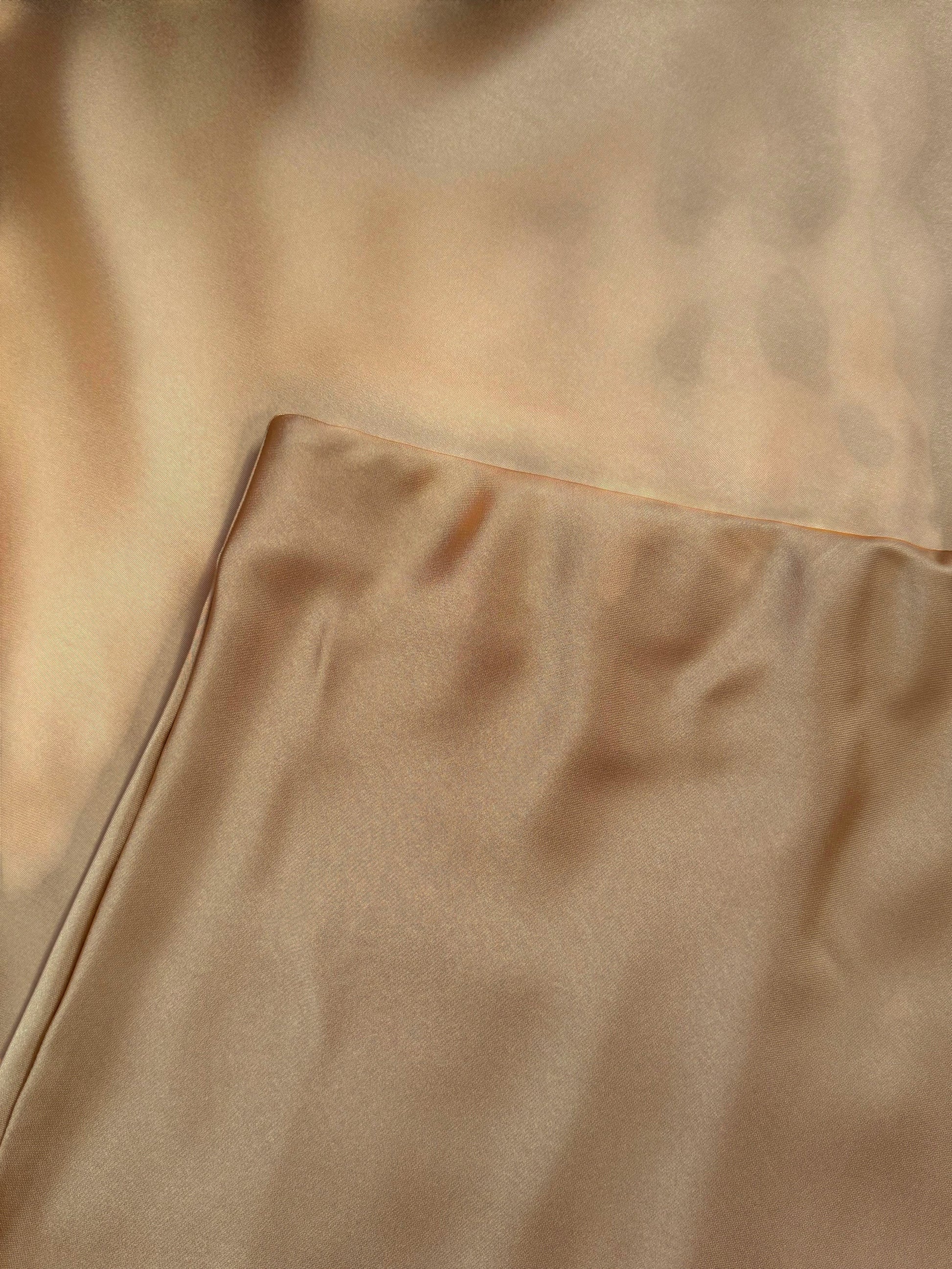 Nesthetics champagne satin midi skirt with a flowing drape and luxurious sheen, perfect for elegant occasions.