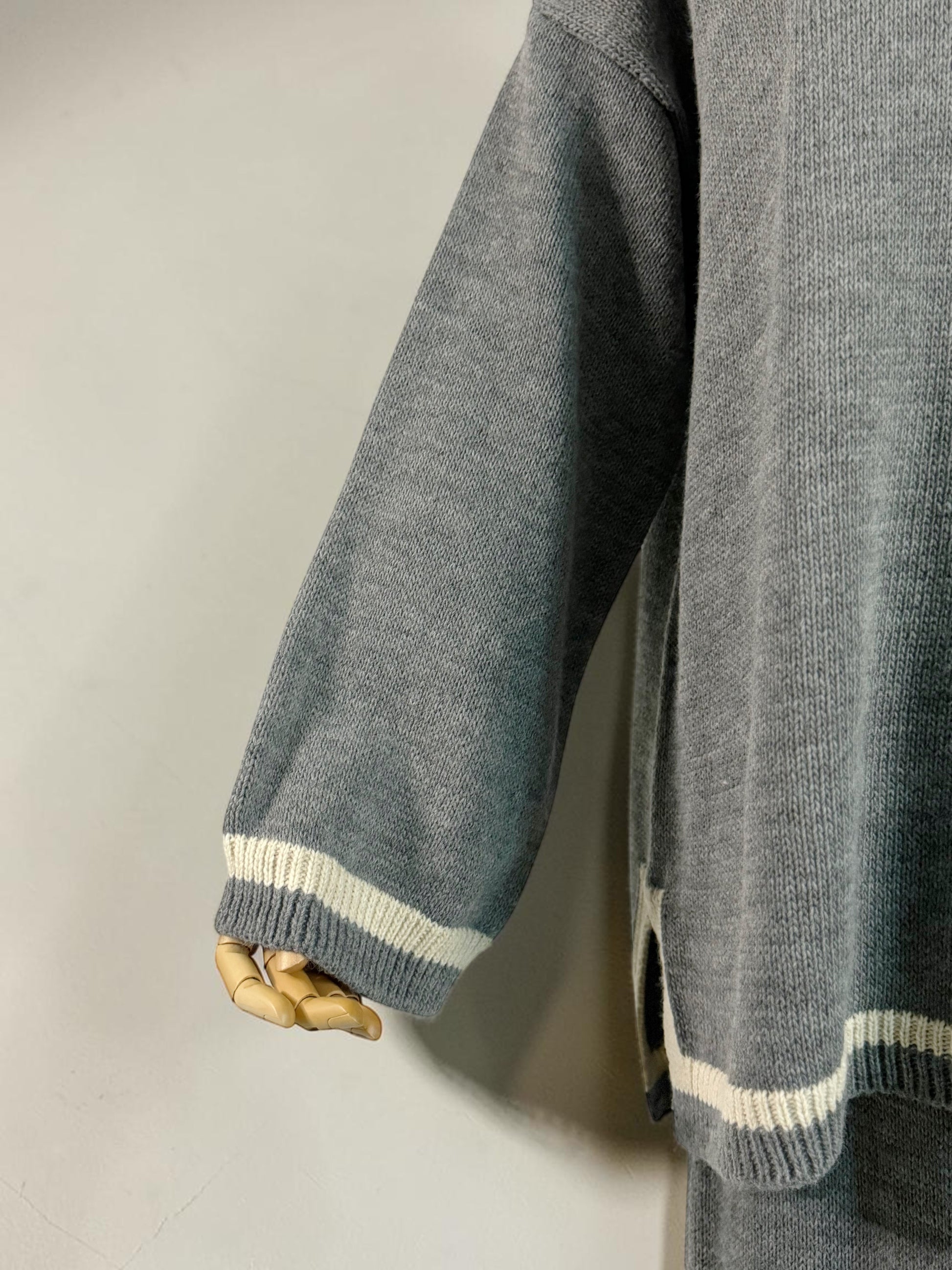 Nesthetics grey knit sweater and skirt set with white stripe details on cuffs and hem.