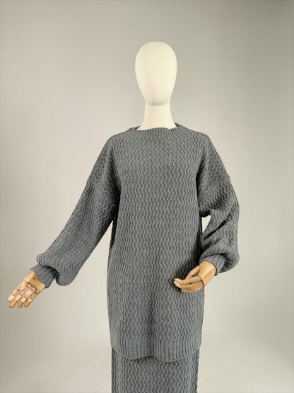 Nesthetics grey knit sweater with balloon sleeves and zigzag pattern, paired with a matching skirt. Mohair blend.
