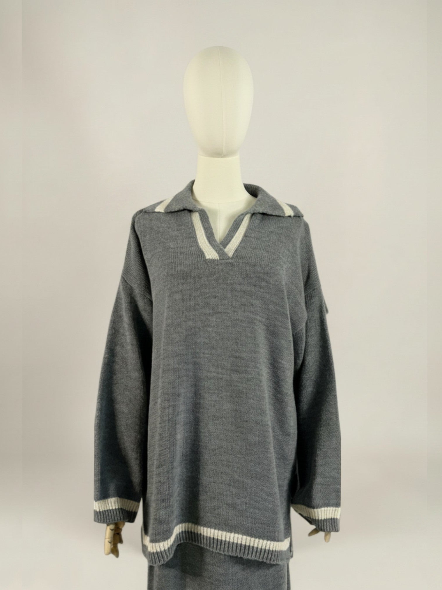 Nesthetics grey knit sweater with V-neck and white trim, paired with matching skirt. Cozy winter set.