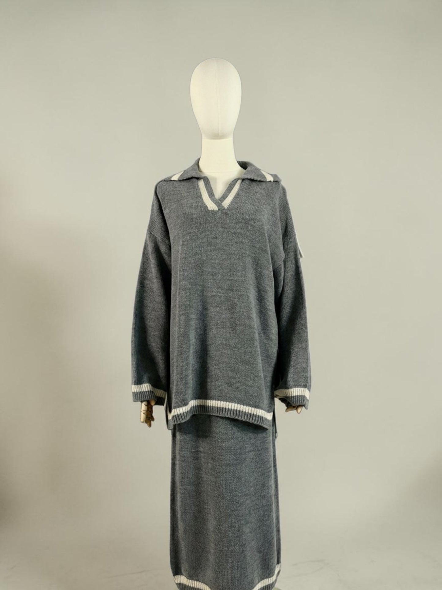 Nesthetics grey knit sweater with V-neck and white trim, paired with a matching midi skirt. Cozy winter set.