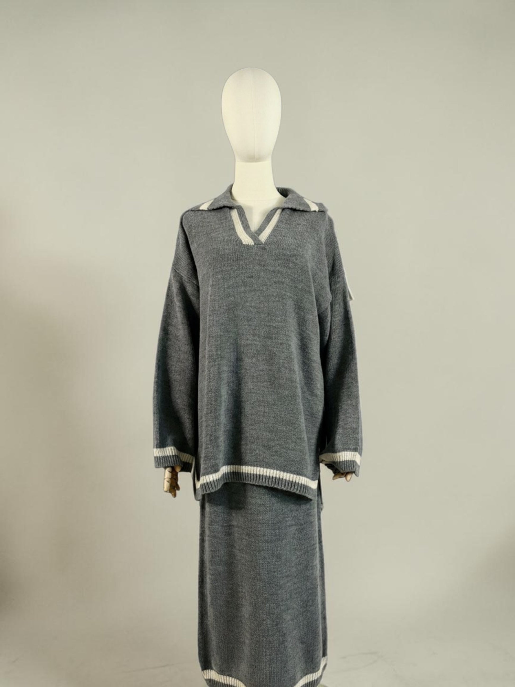 Nesthetics grey knit sweater with V-neck and white trim, paired with a matching midi skirt. Cozy winter set.