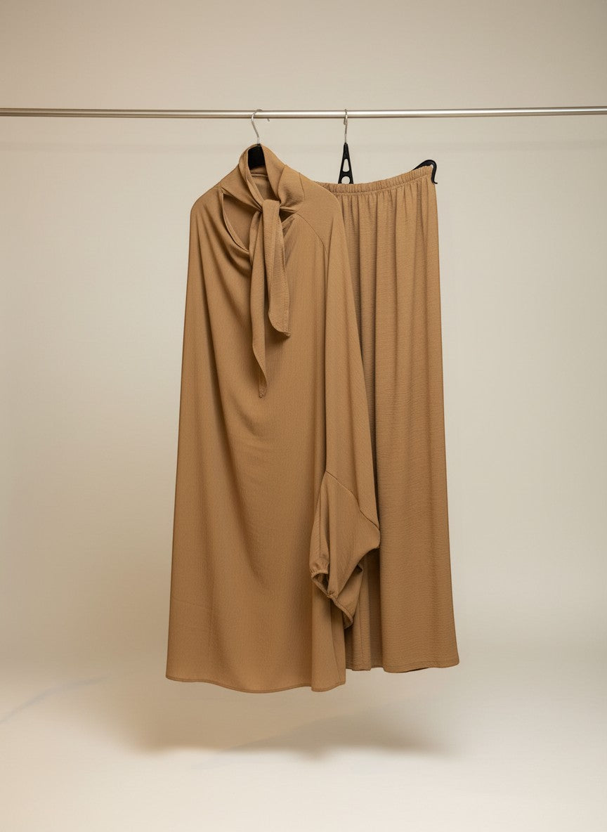 Nesthetics Jazz Jilbab in Bronze. Jilbab mit Rock und elastischem Bund, Ärmeln mit elastischen Bündchen und Schleife am Kragen.