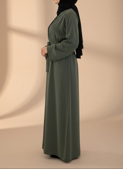Nesthetics Kimono Abaya Almas in Khaki aus Medina-Seide mit Bindegürtel, getragen von einer Frau mit schwarzem Hijab.