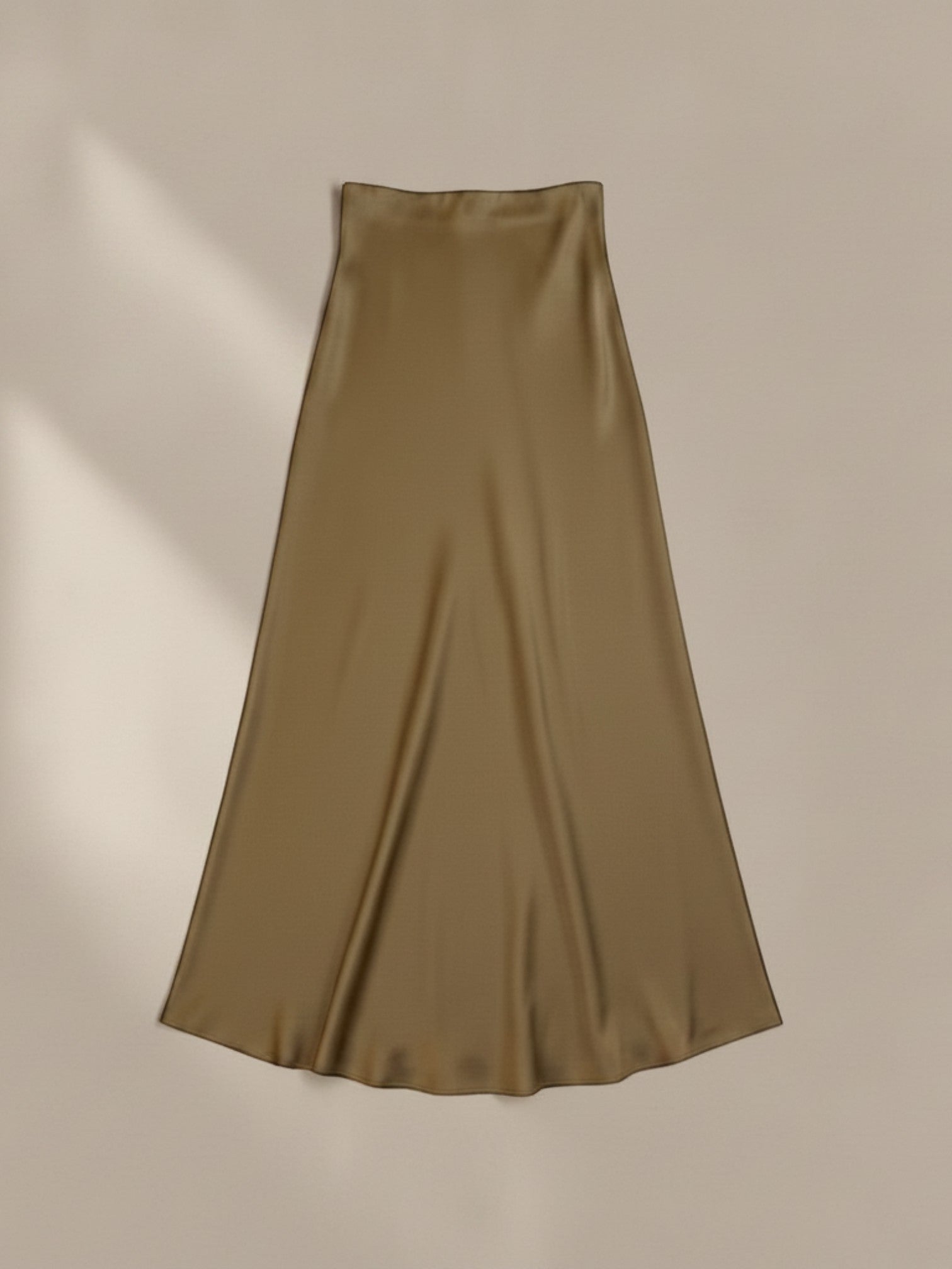 Nesthetics olive green satin midi skirt with a flowing drape and subtle sheen, perfect for elegant occasions.