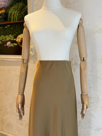 Nesthetics satin midi skirt in a soft tan colour, featuring a flattering A-line cut and a smooth, luxurious finish.