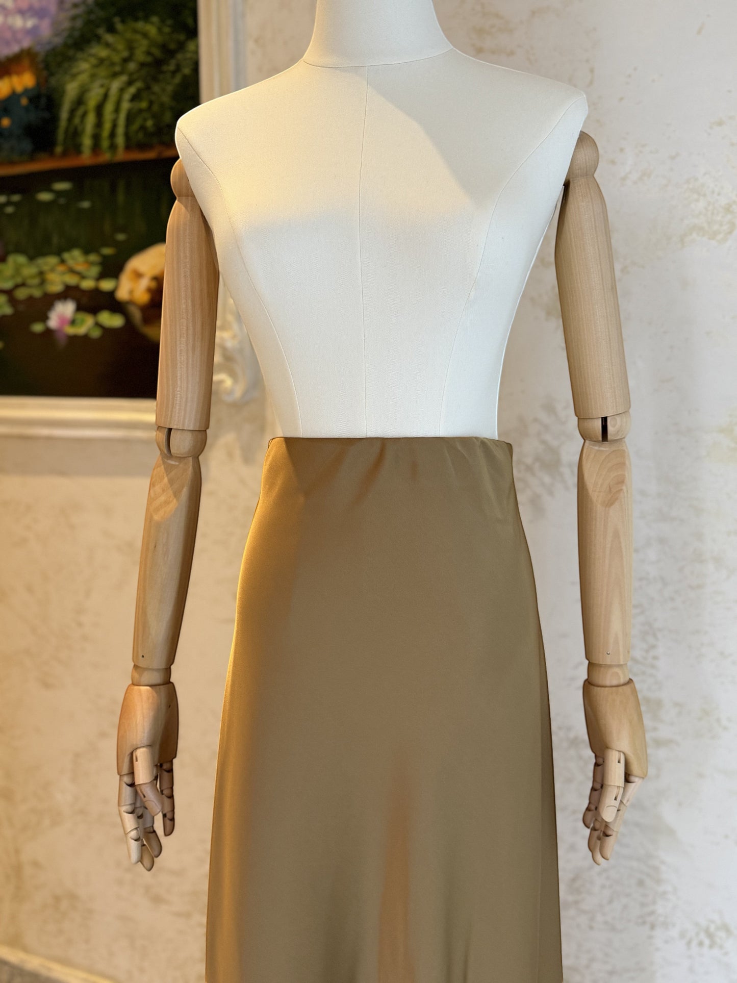 Nesthetics taupe satin midi skirt with a flowing A-line silhouette, perfect for elegant occasions.